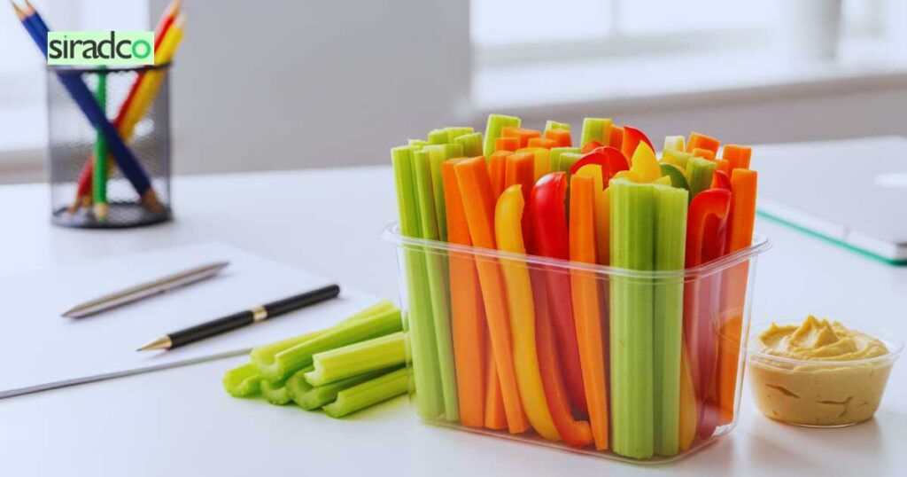 Colorful veggie sticks with hummus low-calorie healthy desk snacks perfect for office sharing