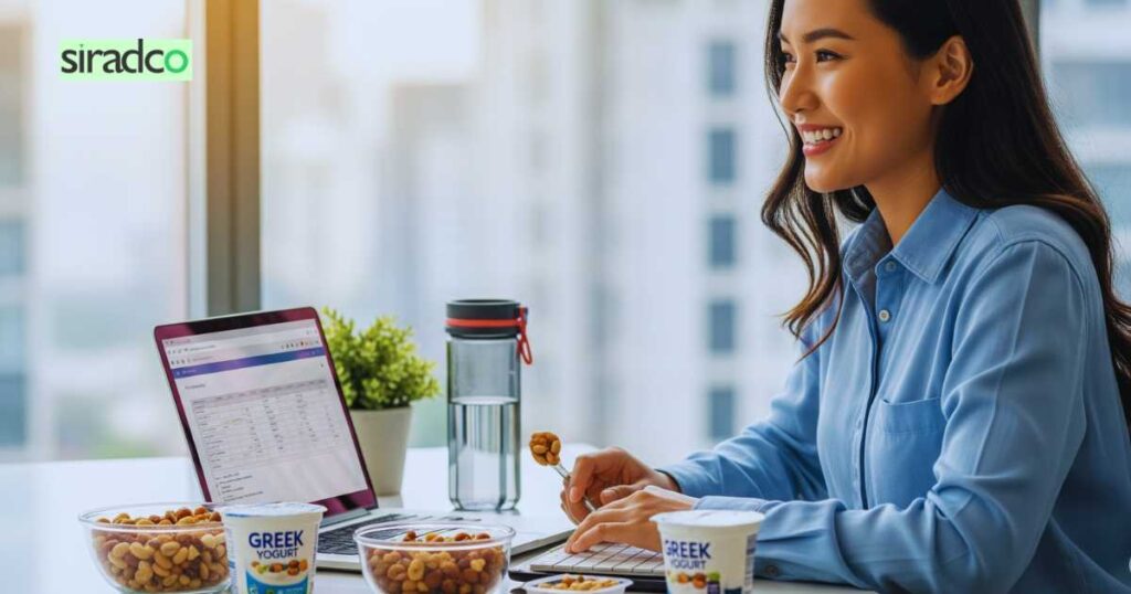 Happy professional enjoying guilt-free healthy desk snacks for improved workplace energy and focus
